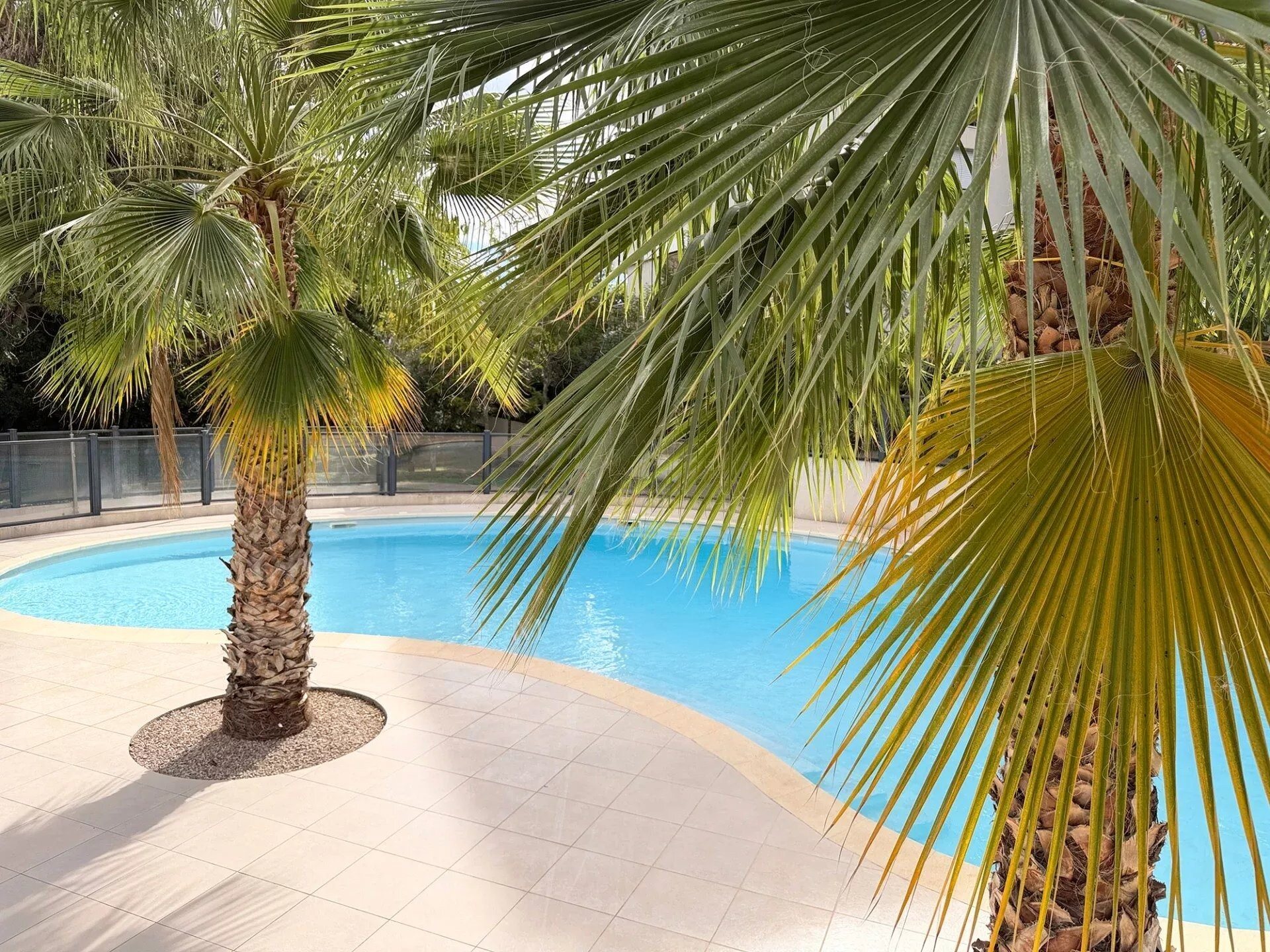 1-bedroom garden-level apartment with pool, garage, and view of greenery